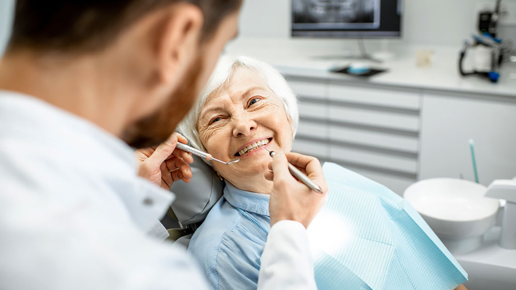 Elderly woman smiling in dentists chair