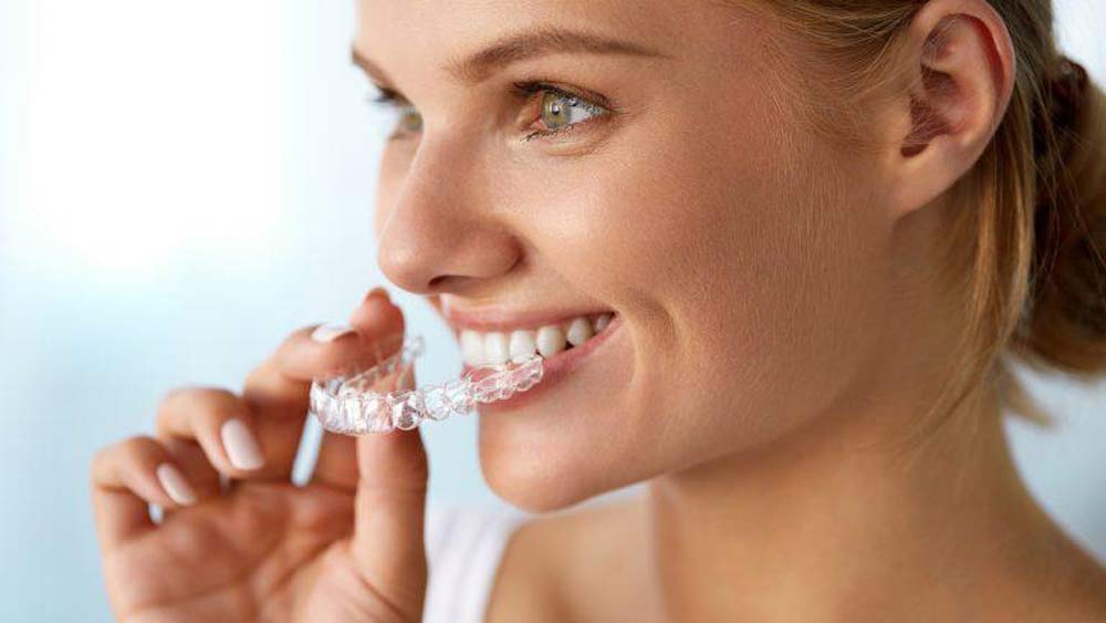 woman using invisalign clear braces